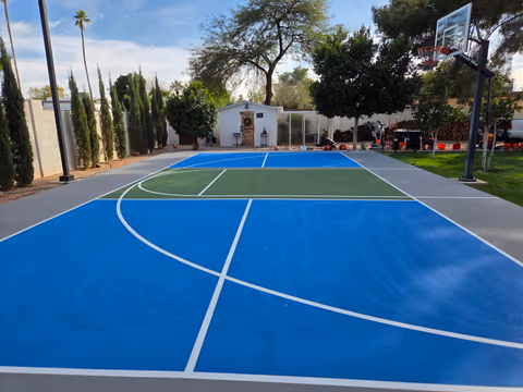 Blue and green backyard basketball court in Arizona