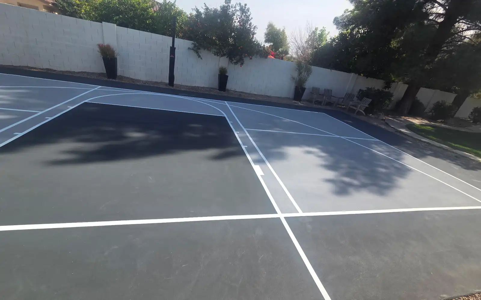 Slate-grey court with fresh white lines after resurfacing in Arizona