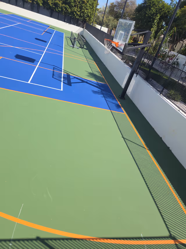Multi-sport court with basketball hoop and fresh striping in Arizona