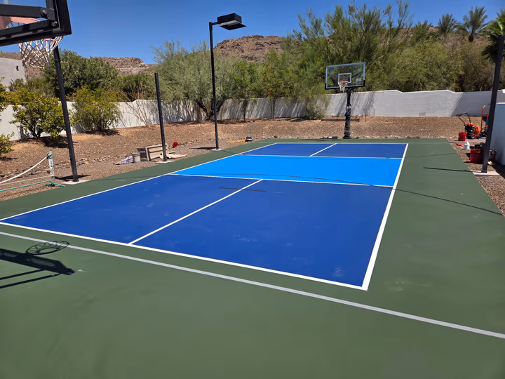 Resurfaced outdoor pickleball court with hoop and Arizona mountain backdrop