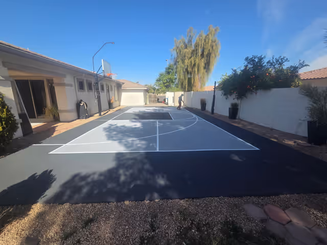 Sport court mid-resurfacing showing fresh acrylic color coats in Arizona