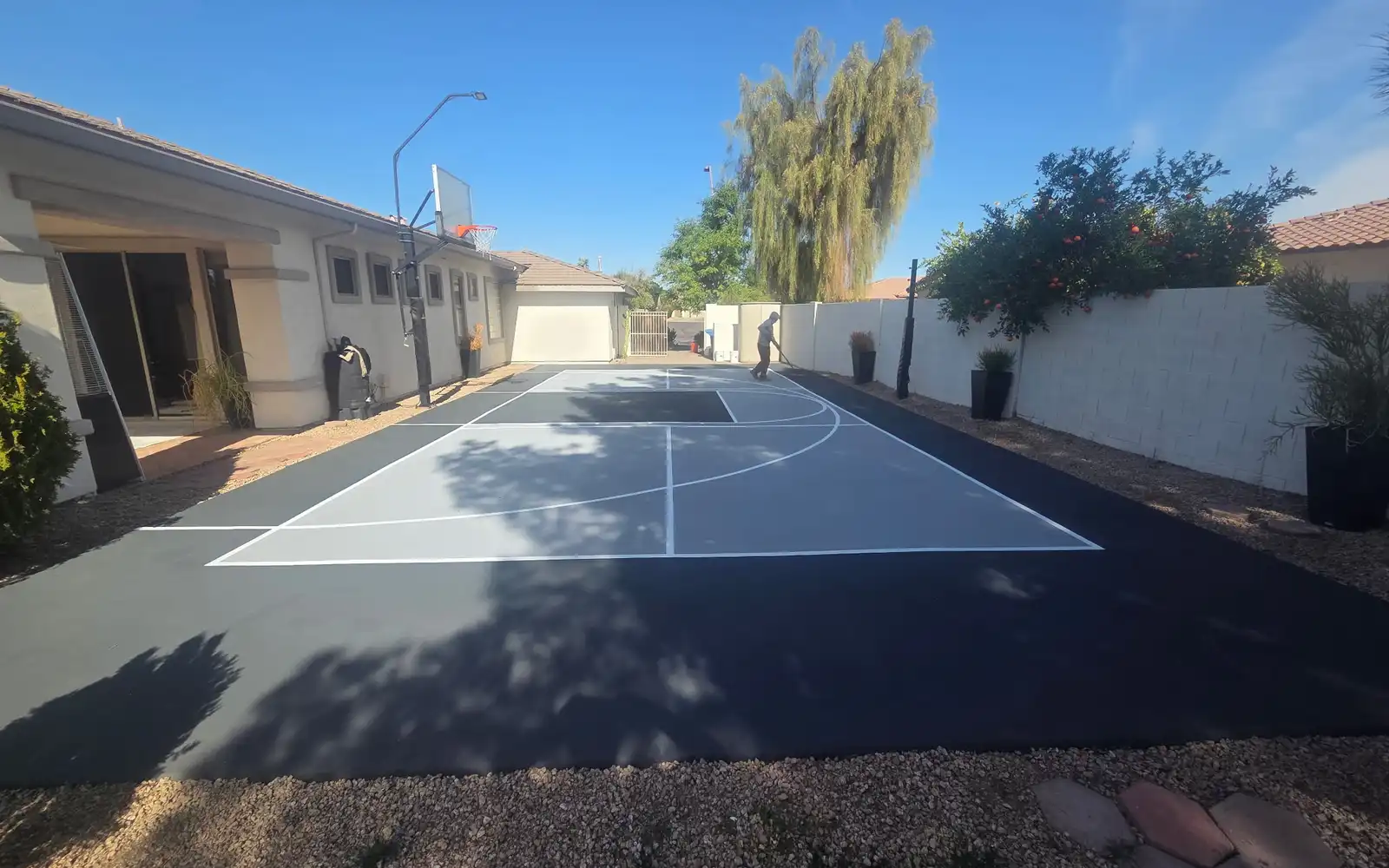 Sport court mid-resurfacing showing fresh acrylic color coats in Arizona